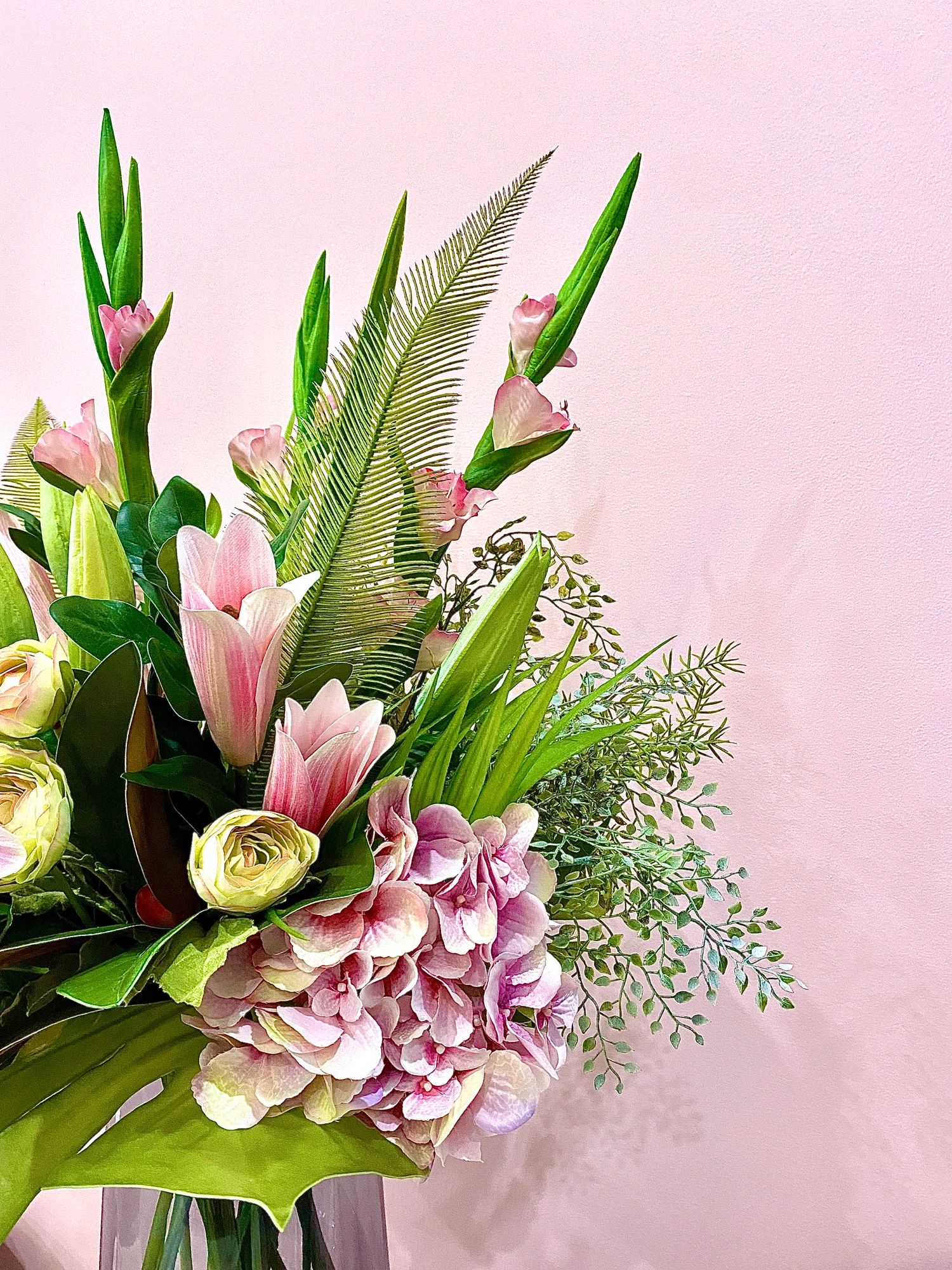 Pink and green flower bouquet with lilies in vase