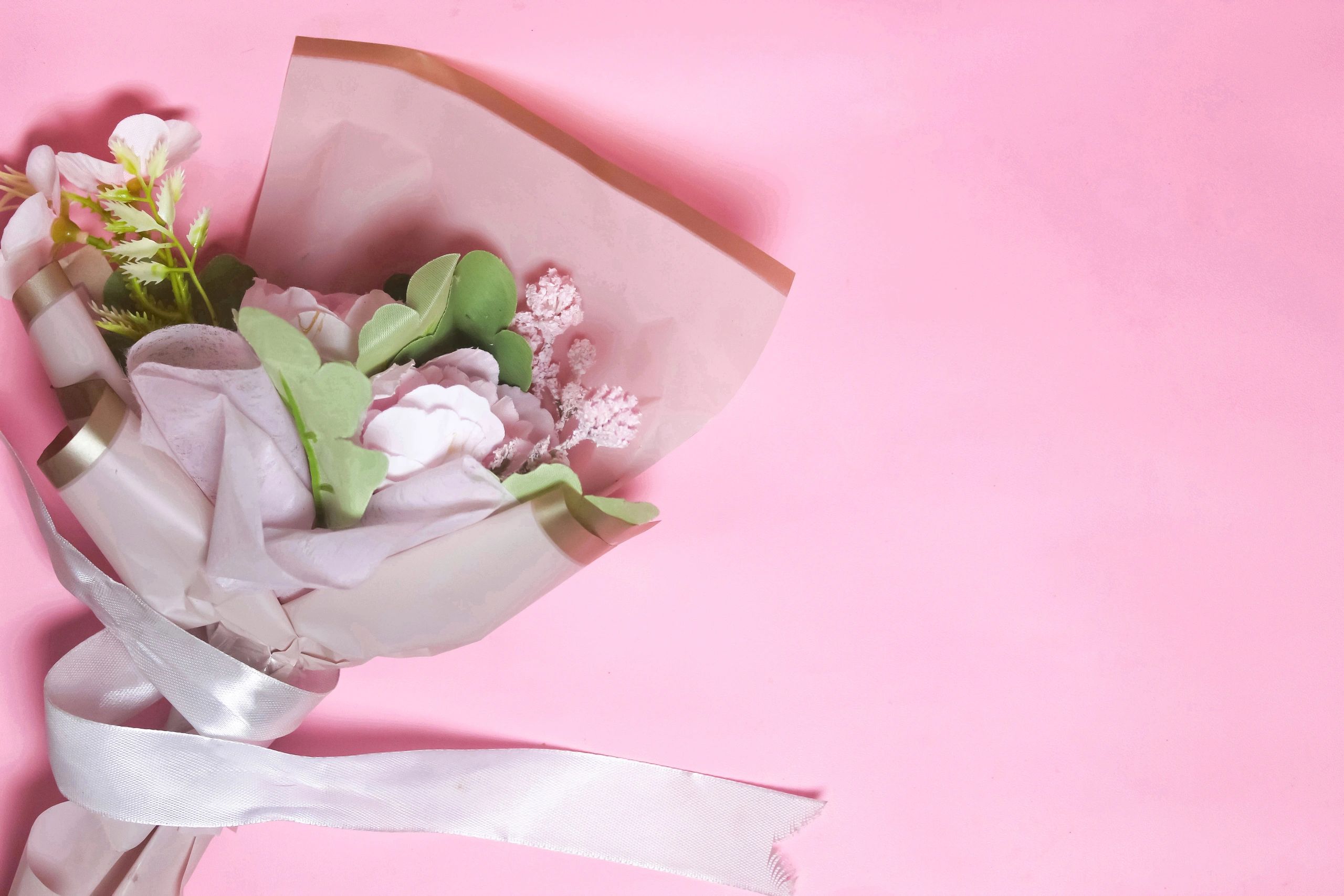 Artificial flower bouquet on pink background